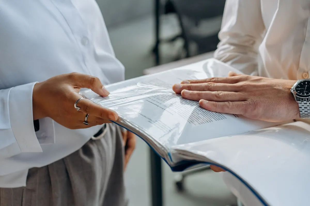 Professionals reviewing evidence organized in a document binder